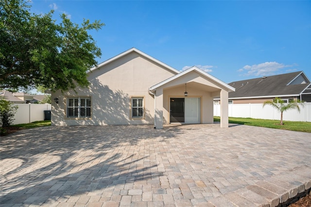 2830 Alton Dr, Kissimmee, FL 34741 - view of front facade with stucco siding and a patio area