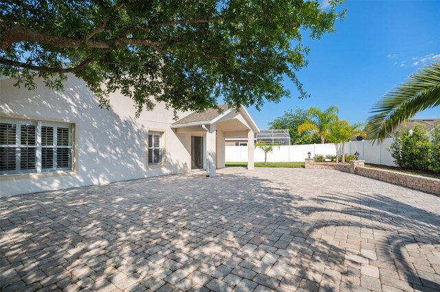 2830 Alton Dr, Kissimmee, FL 34741 - view of front of house with stucco siding, a fenced backyard, and a patio