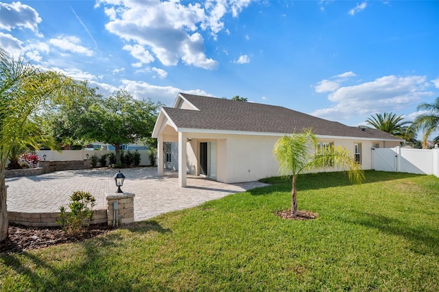 2830 Alton Dr, Kissimmee, FL 34741 - rear view of house with a gate, a patio area, and stucco siding