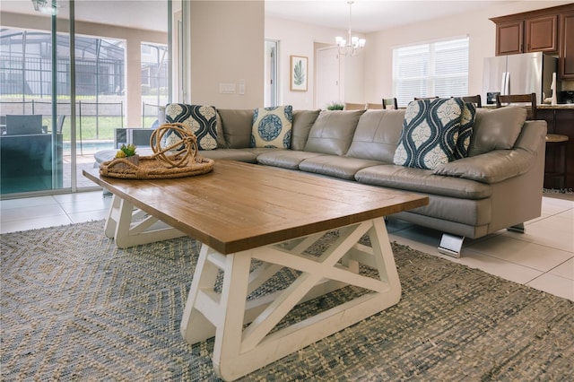 1836 Sandy Park Trl, Kissimmee, FL 34747 - living room featuring a chandelier, light tile patterned floors, and healthy amount of natural light