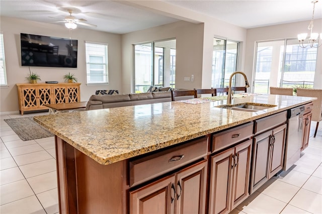 1836 Sandy Park Trl, Kissimmee, FL 34747 - kitchen with a sink, dishwasher, light tile patterned floors, open floor plan, and light stone counters