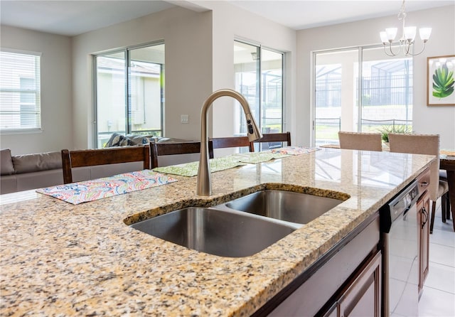 1836 Sandy Park Trl, Kissimmee, FL 34747 - kitchen with a sink, dishwasher, light stone countertops, and open floor plan