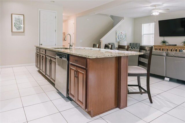 1836 Sandy Park Trl, Kissimmee, FL 34747 - kitchen with stainless steel dishwasher, a sink, a kitchen breakfast bar, and open floor plan