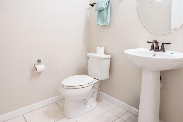 1836 Sandy Park Trl, Kissimmee, FL 34747 - half bathroom with toilet, tile patterned flooring, a sink, and baseboards
