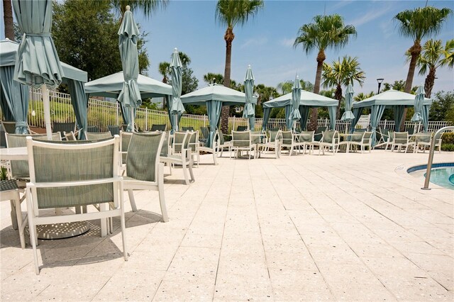 1836 Sandy Park Trl, Kissimmee, FL 34747 - surrounding community featuring a patio, outdoor dining area, and a swimming pool