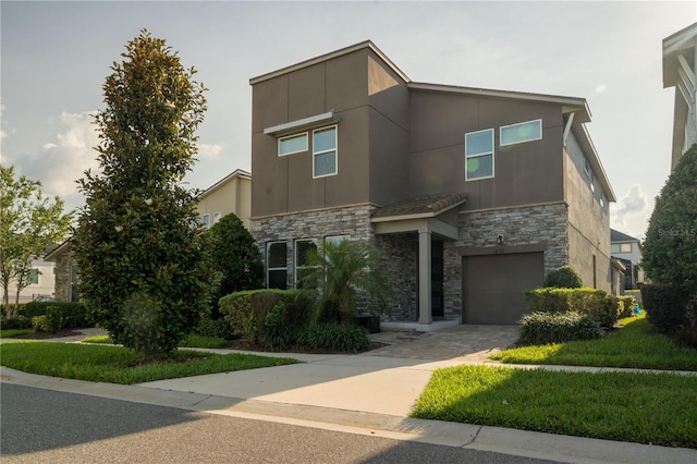 1836 Sandy Park Trl, Kissimmee, FL 34747 - contemporary home with stone siding, an attached garage, driveway, and stucco siding