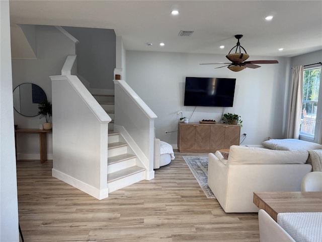 7544 Red Mill Cir, New Port Richey, FL 34653 - living room featuring a ceiling fan, recessed lighting, light wood finished floors, baseboards, and stairs