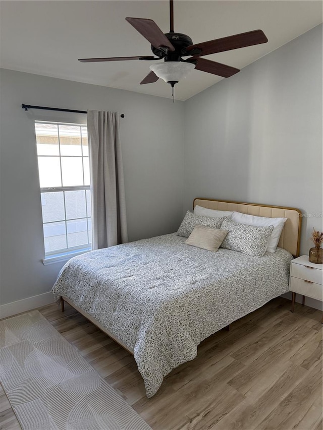 7544 Red Mill Cir, New Port Richey, FL 34653 - bedroom featuring wood finished floors, baseboards, and a ceiling fan