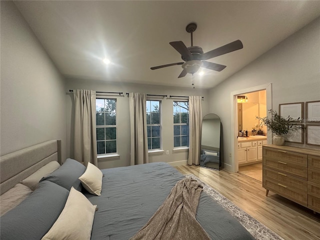 7544 Red Mill Cir, New Port Richey, FL 34653 - bedroom featuring vaulted ceiling, light wood-style flooring, connected bathroom, and ceiling fan