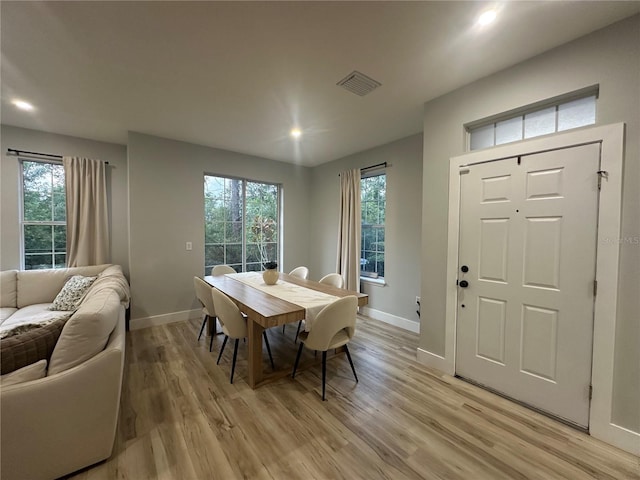 7544 Red Mill Cir, New Port Richey, FL 34653 - dining area featuring light wood-style flooring, baseboards, recessed lighting, and healthy amount of natural light