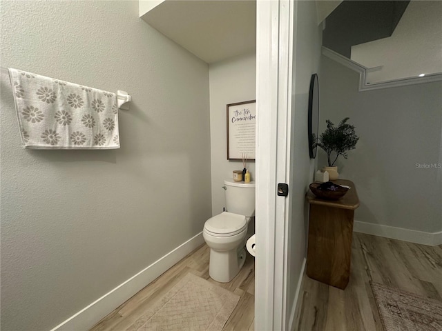 7544 Red Mill Cir, New Port Richey, FL 34653 - bathroom with baseboards, wood finished floors, and toilet