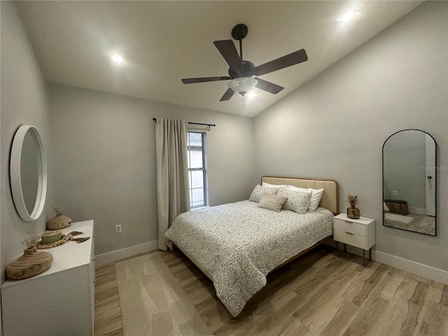 7544 Red Mill Cir, New Port Richey, FL 34653 - bedroom featuring vaulted ceiling, light wood finished floors, baseboards, and ceiling fan