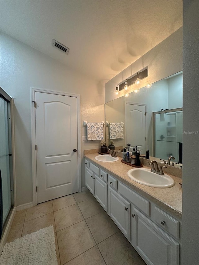 7544 Red Mill Cir, New Port Richey, FL 34653 - bathroom with tile patterned floors, double vanity, and a shower stall