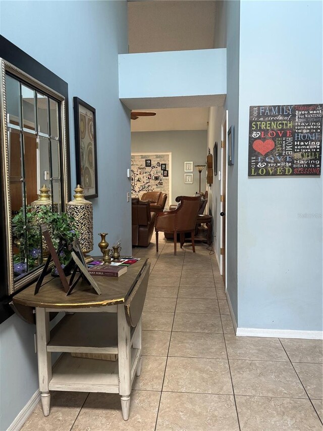 4186 Buglers Rest Pl, Casselberry, FL 32707 - corridor with light tile patterned floors, a high ceiling, and baseboards