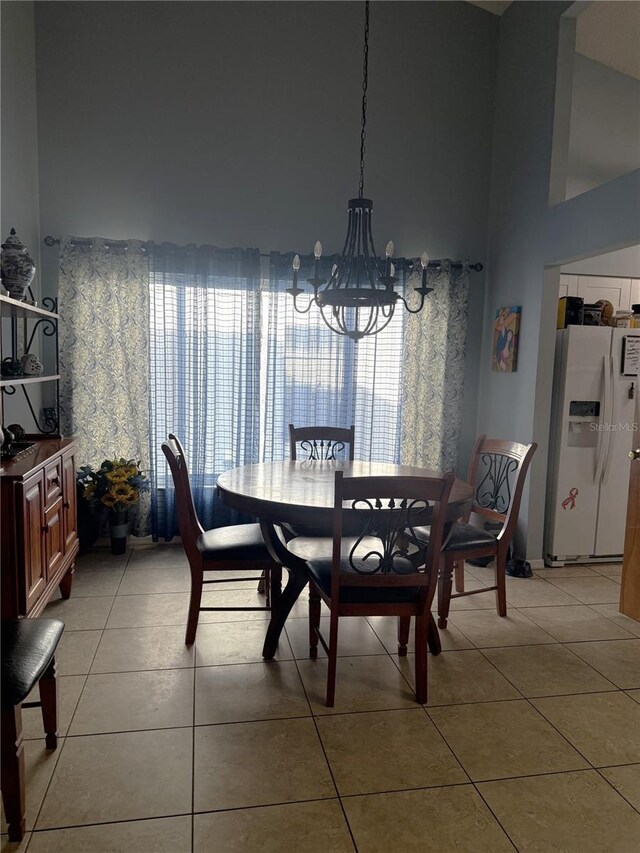 4186 Buglers Rest Pl, Casselberry, FL 32707 - dining area featuring a chandelier, light tile patterned flooring, and a towering ceiling