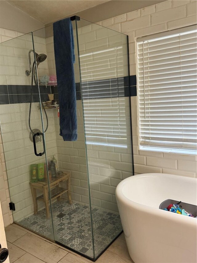 4186 Buglers Rest Pl, Casselberry, FL 32707 - full bath featuring a shower stall, a soaking tub, and tile patterned floors