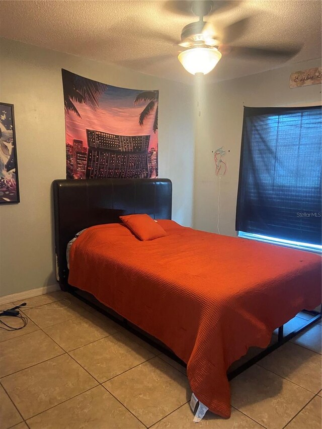 4186 Buglers Rest Pl, Casselberry, FL 32707 - bedroom featuring tile patterned flooring, a textured ceiling, and ceiling fan