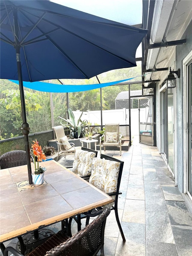 4186 Buglers Rest Pl, Casselberry, FL 32707 - view of patio with outdoor dining space and glass enclosure