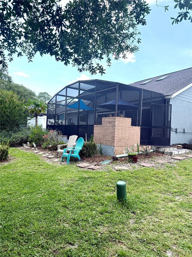 4186 Buglers Rest Pl, Casselberry, FL 32707 - back of house featuring a lawn, a lanai, and roof with shingles