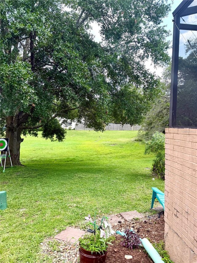 4186 Buglers Rest Pl, Casselberry, FL 32707 - view of grassy yard featuring a lanai