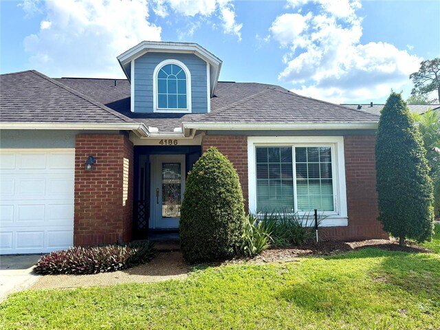 4186 Buglers Rest Pl, Casselberry, FL 32707 - traditional home with brick siding, a front lawn, a shingled roof, and a garage