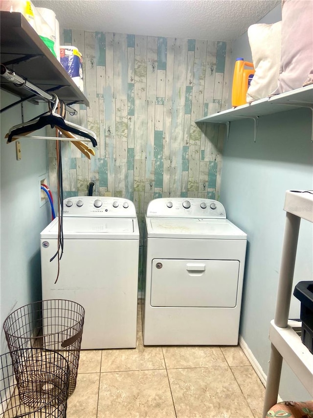 4186 Buglers Rest Pl, Casselberry, FL 32707 - laundry area with independent washer and dryer, wooden walls, tile patterned flooring, and a textured ceiling