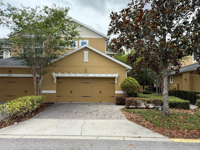 14344 Desert Haven St, Windermere, FL 34786 - view of front of home with stucco siding, driveway, and a garage