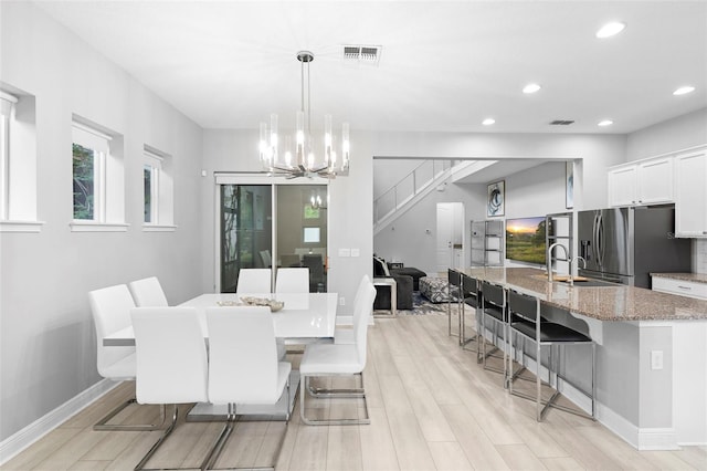 14126 Walcott Ave, Orlando, FL 32827 - dining room with a chandelier, light wood-style floors, recessed lighting, and baseboards
