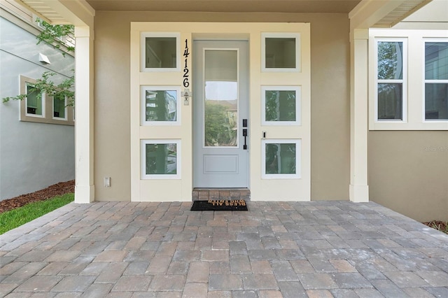 14126 Walcott Ave, Orlando, FL 32827 - doorway to property featuring stucco siding