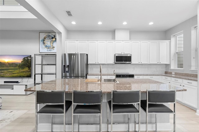 14126 Walcott Ave, Orlando, FL 32827 - kitchen with appliances with stainless steel finishes, a sink, backsplash, light stone counters, and recessed lighting