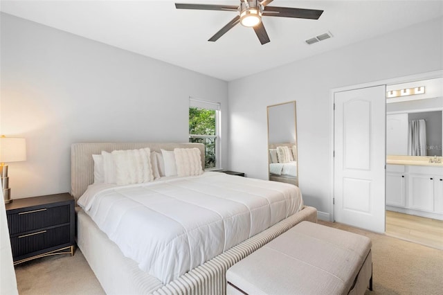 14126 Walcott Ave, Orlando, FL 32827 - bedroom with light carpet, ensuite bathroom, and ceiling fan