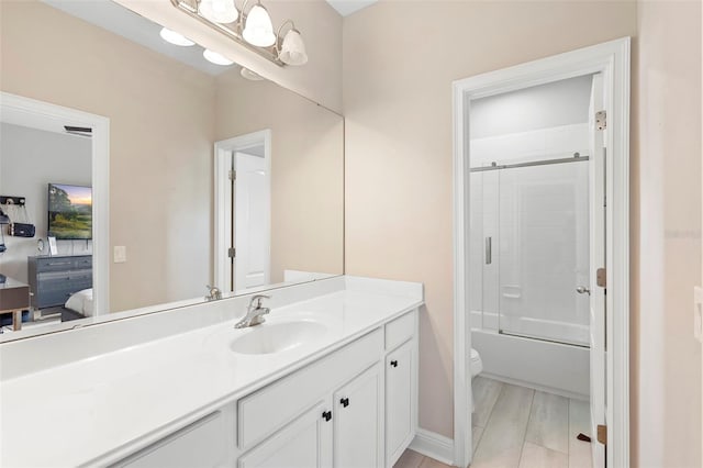 14126 Walcott Ave, Orlando, FL 32827 - ensuite bathroom featuring vanity, toilet, bath / shower combo with glass door, and baseboards