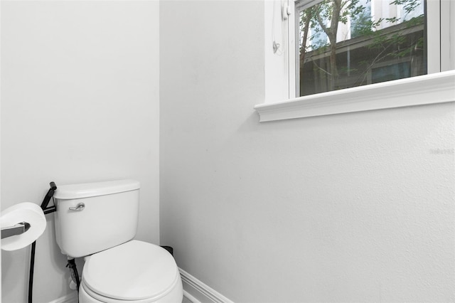 14126 Walcott Ave, Orlando, FL 32827 - bathroom featuring baseboards and toilet