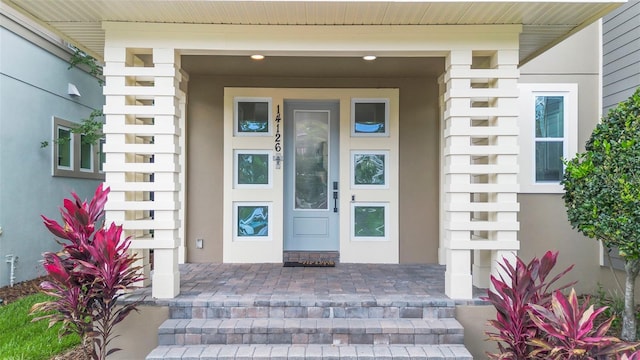 14126 Walcott Ave, Orlando, FL 32827 - view of exterior entry featuring stucco siding and covered porch