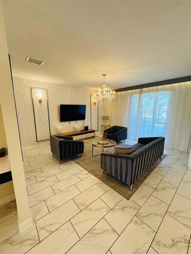 851 Drop Shot Dr, Davenport, FL 33896 - living room with light marble finish floors, baseboards, and a chandelier
