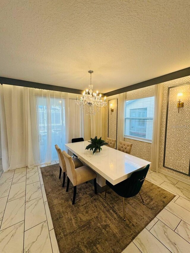851 Drop Shot Dr, Davenport, FL 33896 - dining area featuring light marble finish flooring, a chandelier, and a textured ceiling