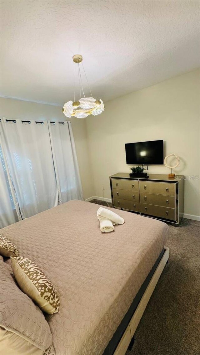 851 Drop Shot Dr, Davenport, FL 33896 - carpeted bedroom with baseboards and a textured ceiling