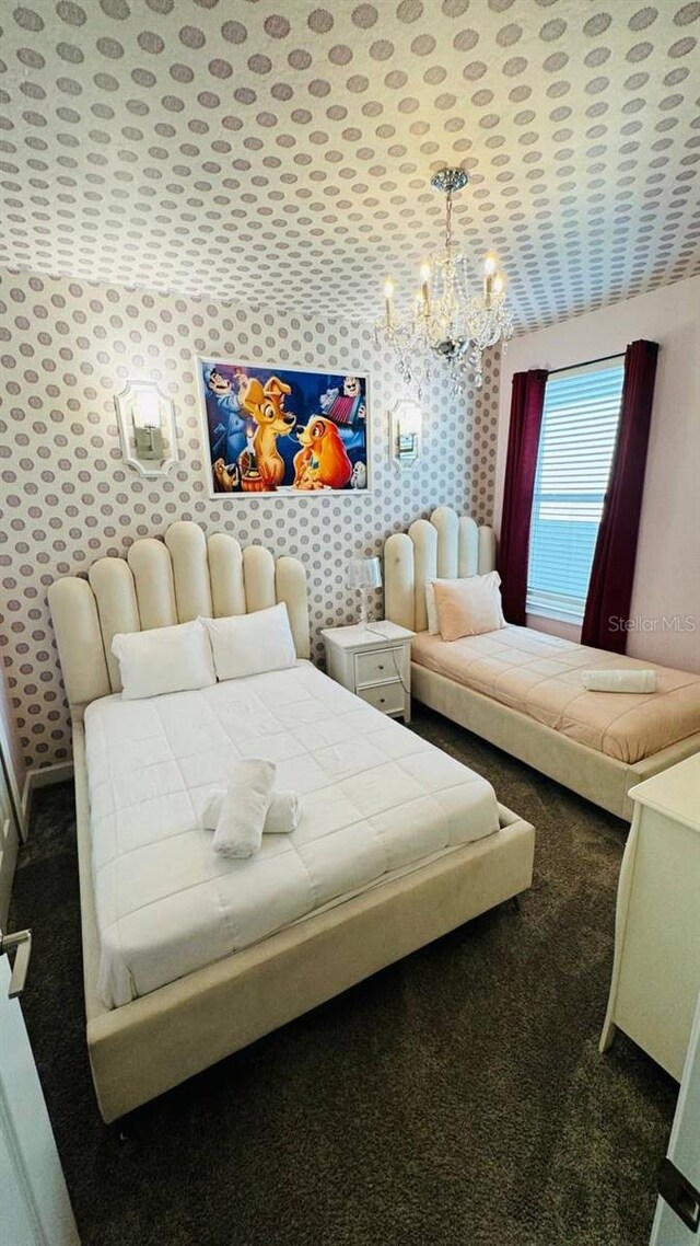 851 Drop Shot Dr, Davenport, FL 33896 - bedroom with a chandelier, carpet flooring, and wallpapered walls