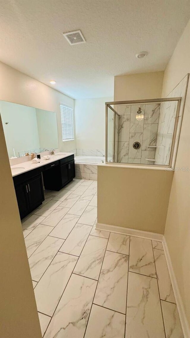 851 Drop Shot Dr, Davenport, FL 33896 - bathroom featuring a bath, walk in shower, marble look tiles, double vanity, and baseboards