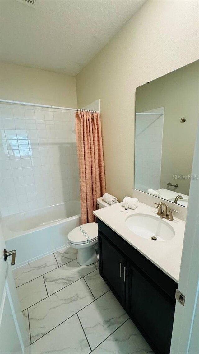 851 Drop Shot Dr, Davenport, FL 33896 - bathroom with vanity, marble finish flooring, toilet, shower / bathtub combination with curtain, and a textured ceiling
