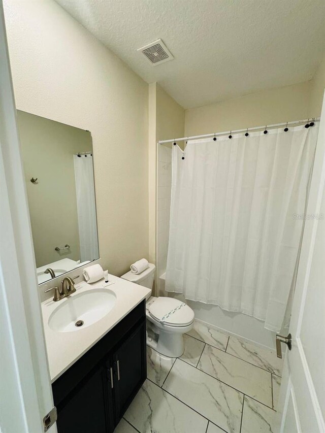 851 Drop Shot Dr, Davenport, FL 33896 - bathroom with vanity, toilet, shower / tub combo, marble look tile flooring, and a textured ceiling
