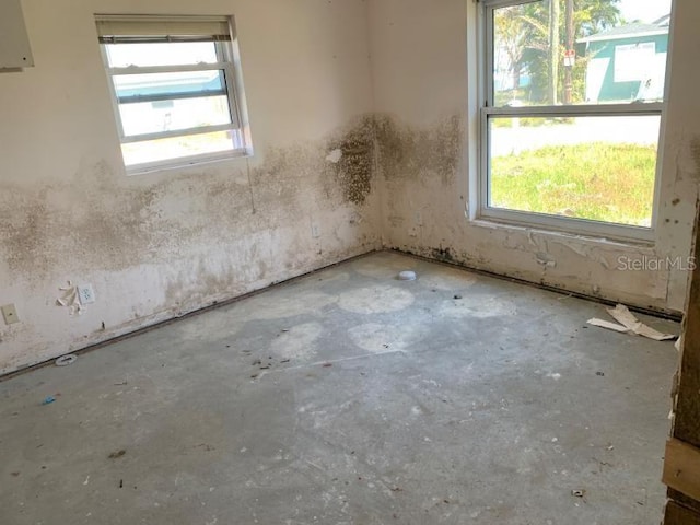 365 145th Ave E, Madeira Beach, FL 33708 - unfurnished room featuring plenty of natural light and concrete floors