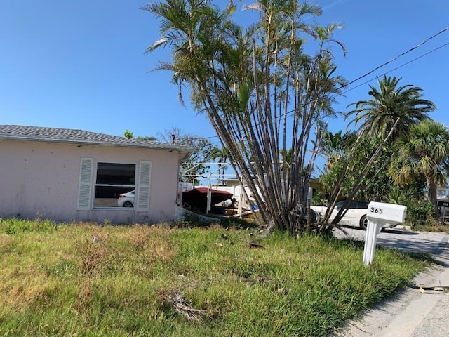 365 145th Ave E, Madeira Beach, FL 33708 - view of side of property featuring stucco siding