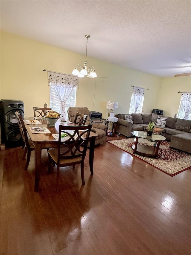 319 N Scenic Hwy, Frostproof, FL 33843 - dining room with healthy amount of natural light, a chandelier, and dark wood-style floors
