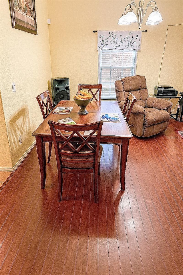 319 N Scenic Hwy, Frostproof, FL 33843 - dining room with wood finished floors, a chandelier, and baseboards