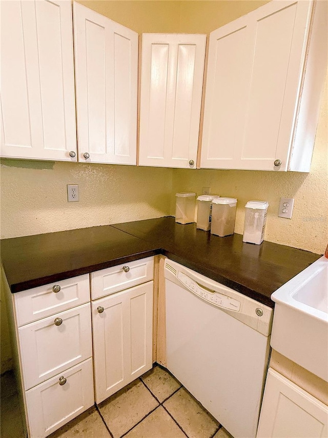 319 N Scenic Hwy, Frostproof, FL 33843 - kitchen with dishwasher, white cabinets, dark countertops, and a textured wall
