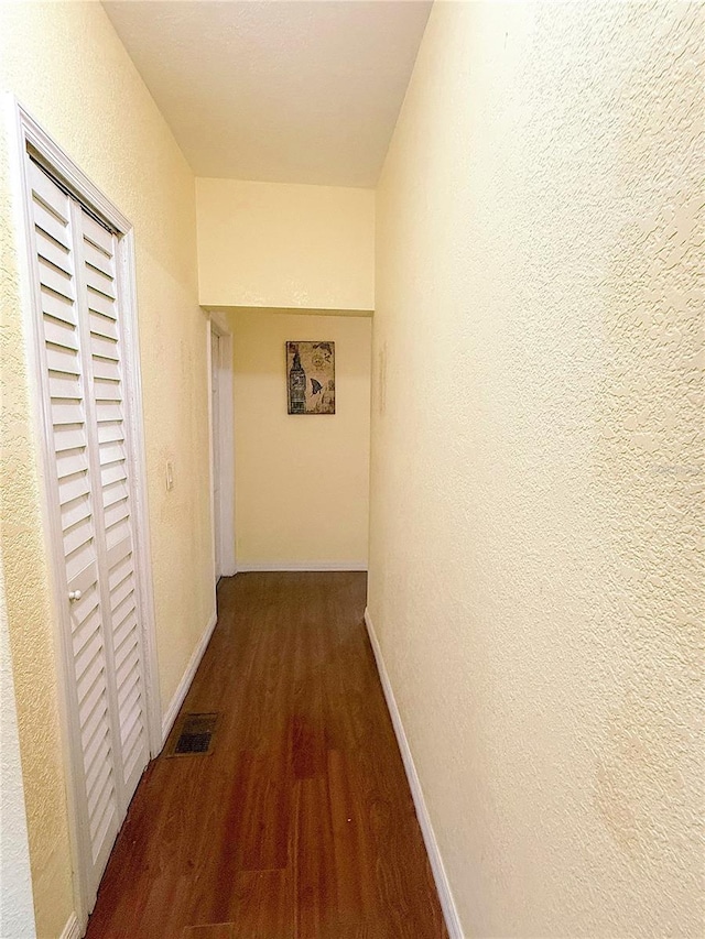 319 N Scenic Hwy, Frostproof, FL 33843 - hallway with wood finished floors, a textured wall, and baseboards
