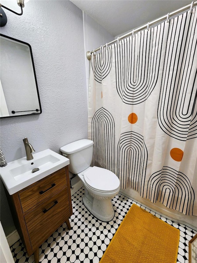 420 61st Ave S, Saint Petersburg, FL 33705 - full bathroom with vanity, toilet, and a textured wall