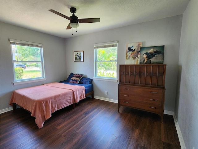 420 61st Ave S, Saint Petersburg, FL 33705 - bedroom featuring multiple windows, dark wood finished floors, baseboards, and ceiling fan