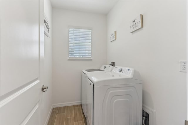 4122 Sagefield Dr, Saint Cloud, FL 34773 - laundry area featuring washer and clothes dryer, baseboards, and wood finish floors